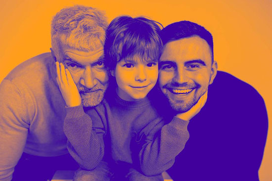 Two men and a child face the camera