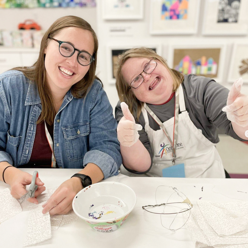 ACT student painting with volunteer